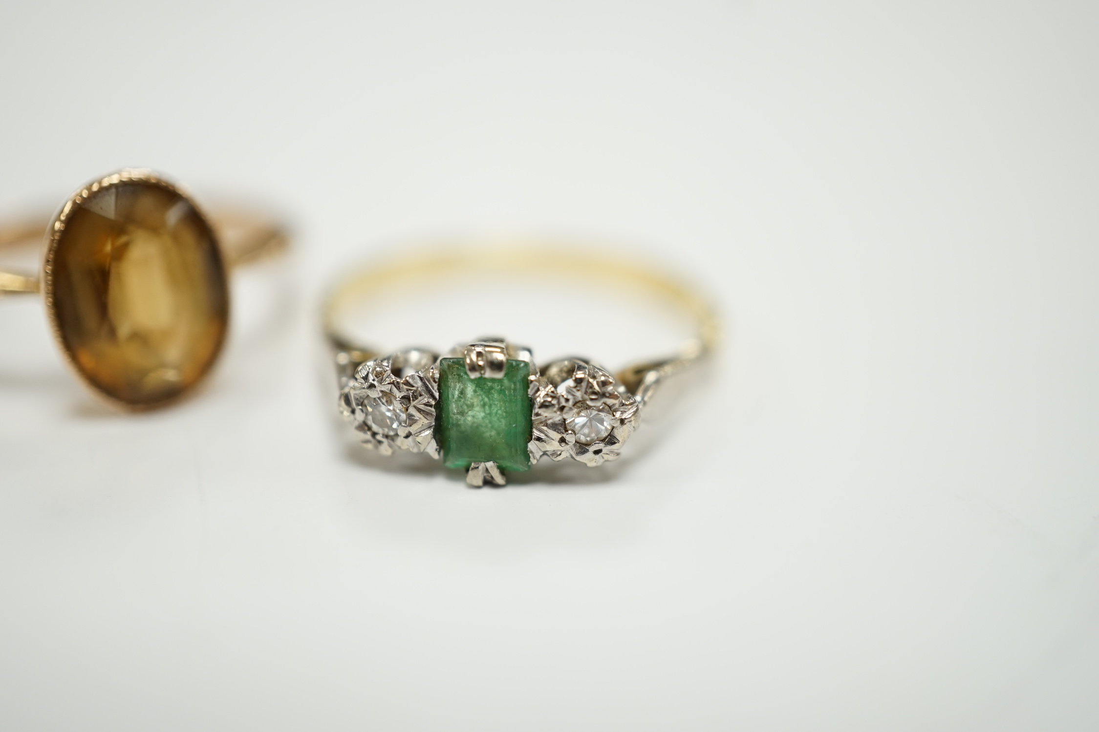 A 750, single stone emerald and two stone illusion set diamond ring and a 9ct and citrine set ring.